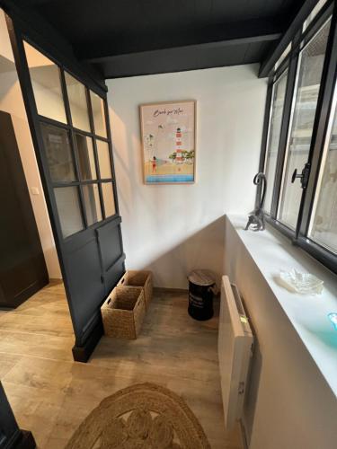 Cette chambre dispose d'un couloir avec une porte et un tapis. dans l'établissement La Manufacture du Sable, à Berck-sur-Mer