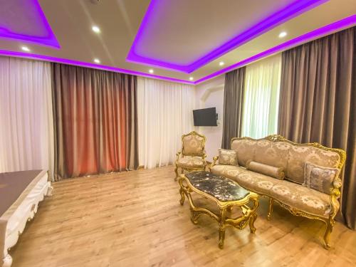 a living room with a couch and a chair at Red Hill Hotel in Tirana