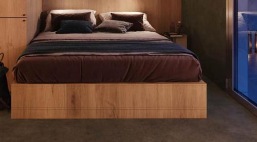 a bed with a wooden frame in a bedroom at The View in Copenhagen