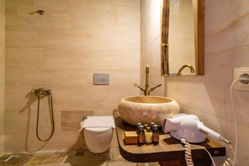 a bathroom with a sink and a toilet at Cappadocia Snora Cave in Nevsehir