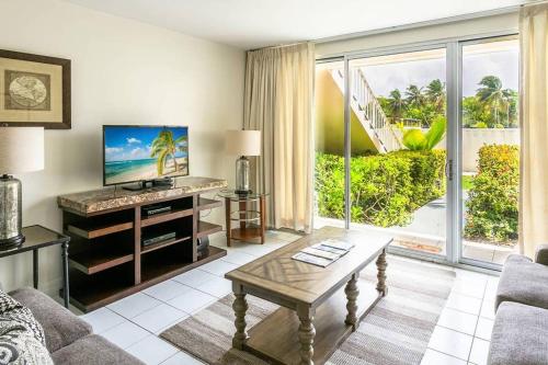 a living room with a couch and a table at Beach Living at Island Pine Villas BLP in George Town