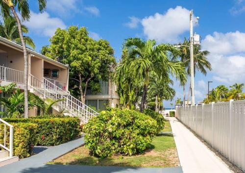 a walkway in front of a building with palm trees at Beach Living at Island Pine Villas BLP in George Town