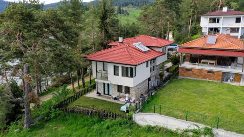 an aerial view of a house with a red roof at Къща за гости СИАНА in Dospat