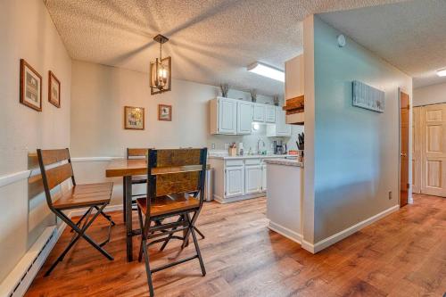 a kitchen and dining room with a table and chairs at Riverfront family-friendly condo in Avon