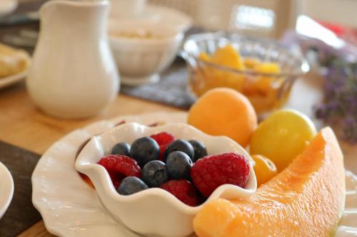a bowl of fruit on a plate on a table at Relais Ca' Morenica in Valeggio sul Mincio