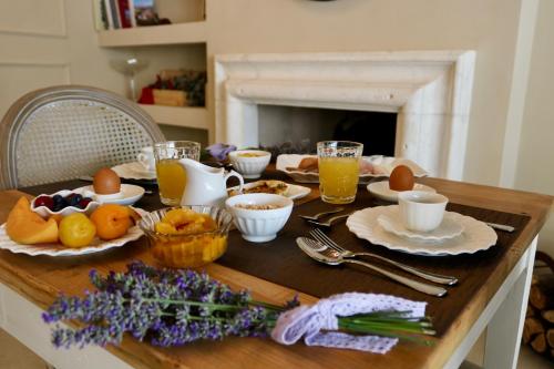 a table with breakfast foods and drinks on it at Relais Ca' Morenica in Valeggio sul Mincio