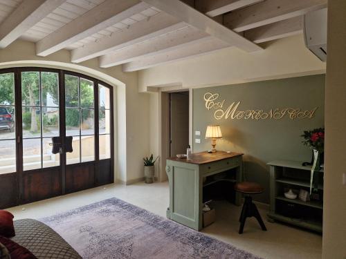 a bedroom with a bed and a desk and a window at Relais Ca' Morenica in Valeggio sul Mincio