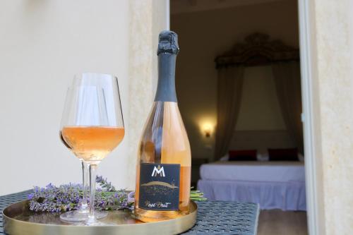 a bottle of wine and a glass on a table at Relais Ca' Morenica in Valeggio sul Mincio