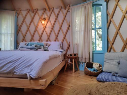 a bedroom with a large bed and a window at Love Frequency - יורט קסום במתת in Mattat