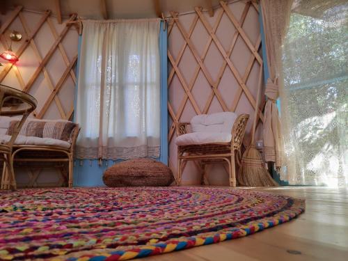 a room with a yurt with a rug on the floor at Love Frequency - יורט קסום במתת in Mattat