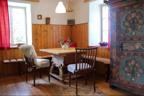 a dining room with a wooden table and chairs at Monika am Masenberg in Vorau