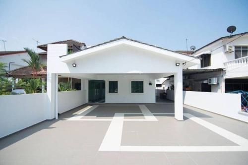 a white house with a large driveway at Peace Casa - Homely & Cosy in Butterworth