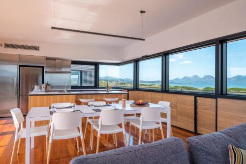 a kitchen and dining room with a table and chairs at Elements - Freycinet Holiday Houses in Dolphin Sands