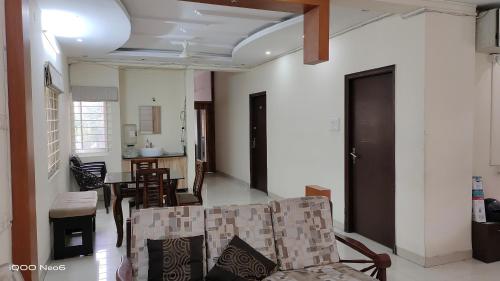 a living room with a couch and a table at Hitech Shilparamam Guest House in Hyderabad