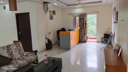 a living room with a couch and a table at Hitech Shilparamam Guest House in Hyderabad