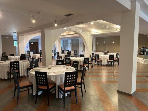 a dining room with white tables and chairs at Hotel PentHouse in Perugia