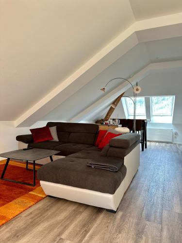 a living room with a couch and a table at Wohnen über den Dächern von Bregenz in Bregenz
