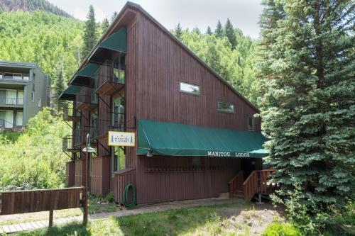 a building with a green awning on the side of it at Manitou Lodge 2 Hotel Room in Telluride