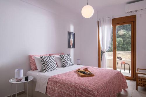 a bedroom with a bed with a tray on it at Beachfront Orange apt-Ligaria Beach in Lygaria