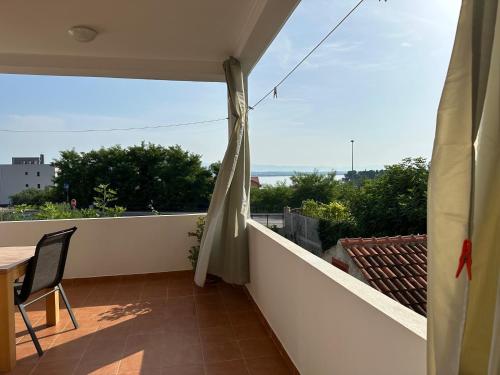 a balcony with a table and a view at Apartman Mrgic in Preko