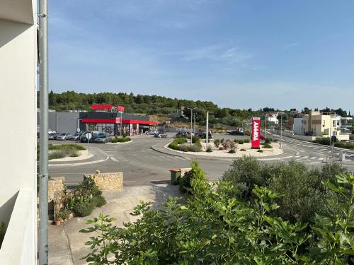 a view of a parking lot with a gas station at Apartman Mrgic in Preko