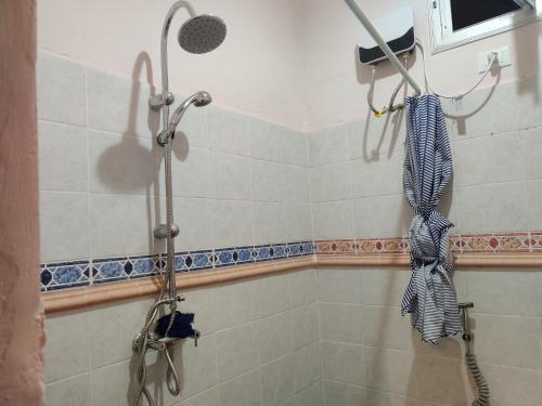 a shower in a bathroom with a shower head at Keur Magatte in Saint-Louis