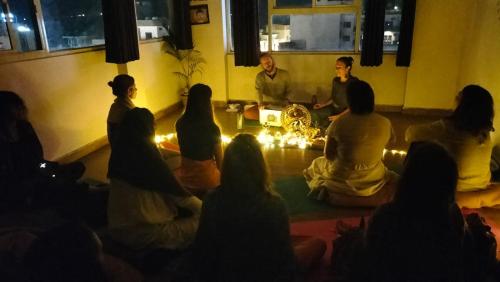 a group of people sitting on the floor in a room at Rudram Hotel Yoga & Ayurveda Retreat in Rishīkesh