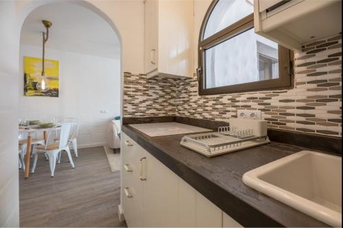 a kitchen with a sink and a counter top at in front of the pool, large terrace, elegant & confortable, Wi-Fi in Costa Calma