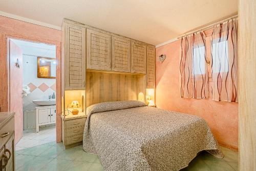 a bedroom with a bed and a bathroom at Claude&Kate's dream house in Porto San Paolo