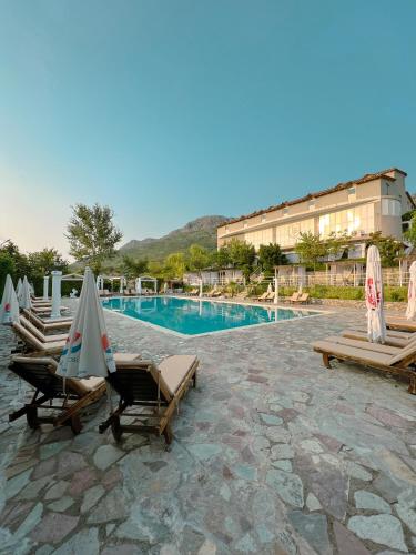 a resort with a swimming pool and lounge chairs at BlackStone.Shkodra in Shkodër