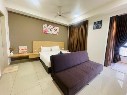a bedroom with a bed and a couch in it at Melaka Town Homestay Bali Residences Apartment in Melaka