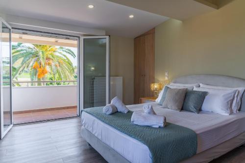 a bedroom with a large bed with towels on it at Amor Villa in Laganas