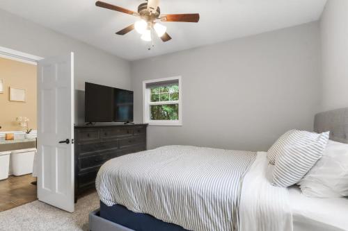 a bedroom with a bed and a ceiling fan at New Pet Friendly Walking Distance to Lake Front in Lake Geneva