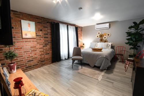 a bedroom with a bed and a brick wall at Casa San Marcos UNO in Mexicali