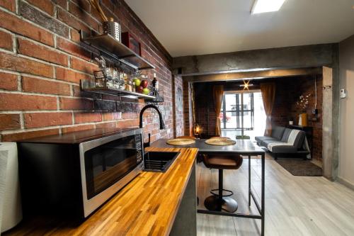 a kitchen with a brick wall and a counter top at Casa San Marcos UNO in Mexicali