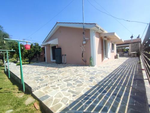 a house with a stone walkway next to a building at Feels like home. in Koukounariá