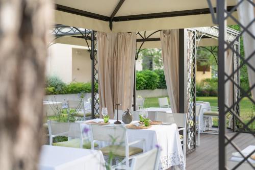 a table set up for a wedding under a tent at Laguna Park Hotel 4Superior in Bibione
