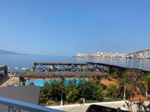 a view of a resort with a swimming pool and the water at Blue Breeze Attic Apartments in Sarandë