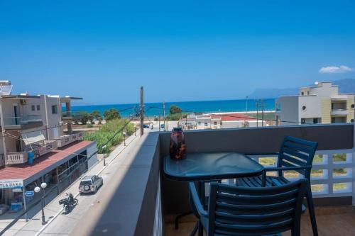 a table on a balcony with a view of the ocean at Sunflower in Kissamos