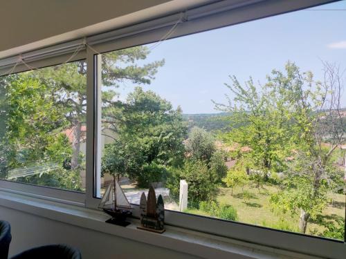 a window with a view of a yard at Apartment Betty in Labin