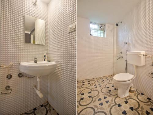a bathroom with a white toilet and a sink at Goa Garden 6BHK Villa with Private Pool Near Baga in Marmagao