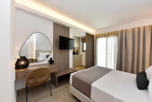 a hotel room with a bed and a mirror at Anais Milos Suites in Adamas
