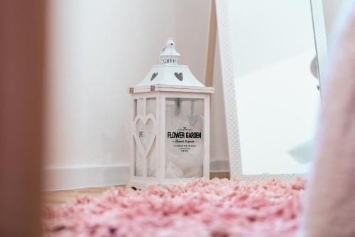 a lantern sitting on the floor next to a pink carpet at Dinara View Apartment-Knin in Knin