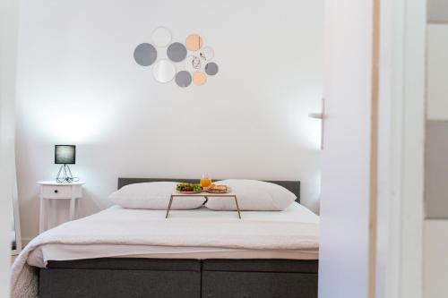a bedroom with a bed with a tray of fruit on it at Dinara View Apartment-Knin in Knin
