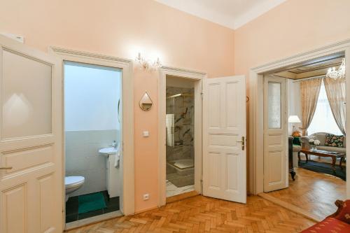 a bathroom with a shower and a toilet in a room at Stunning Charles Bridge Apartment in Prague