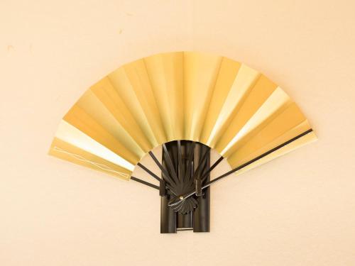 a fan is hanging on a wall at 枳殻の杜 Kikoku no mori in Kyoto