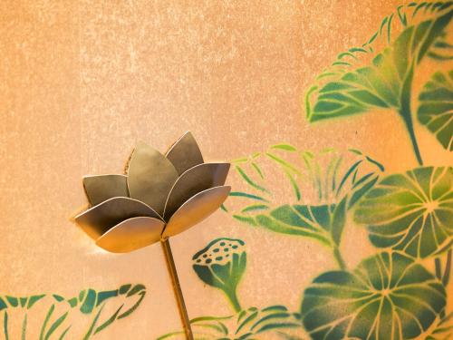 a painting of a flower on a wall at 枳殻の杜 Kikoku no mori in Kyoto