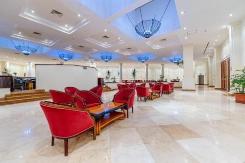 a conference room with red chairs and a whiteboard at Siva Sharm Resort & SPA in Sharm El Sheikh