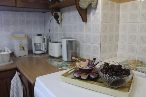 a kitchen with a sink with a bowl of food on it at Malamo's home in Kissos