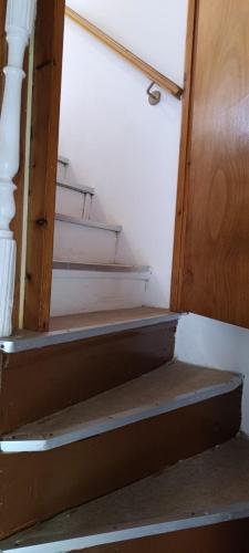a set of stairs with a wooden door at Athina Country House in Kouramádes